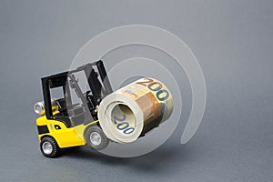 A yellow loader stands on the rear wheels holding a big roll bundle of Euro. concept of attracting investment, issuing