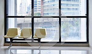 Yellow lobby waiting chair with building view background and copy space