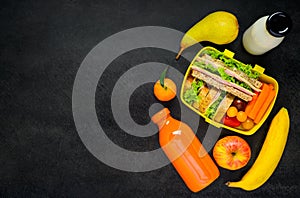 Yellow Lunch Box with Fruits and Milk on Copy Space