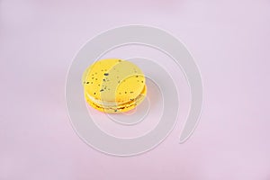 Yellow macaron on pink background, dessert