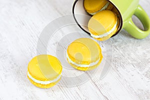 Yellow macaroons and green cup