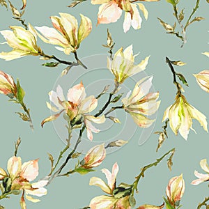 Yellow magnolia flowers on a twig on light green background. Seamless pattern. Watercolor painting. Hand drawn and colored.