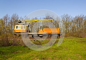 Yellow maintenance train parked on rails used for railroad maintenance