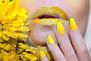 Yellow manicure and makeup .