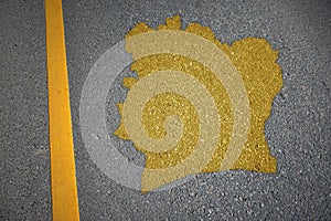 yellow map of cote divoire country on asphalt road near yellow line