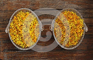 Yellow marigold petal, Tagetes, herbal infusion, herbal tea, Tisanes, Almost dry marigold petal for making herbal tea in glass