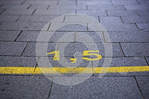 Yellow marking on the street in order to guide social distancing due to the coronavirus or covid-19 pandemic