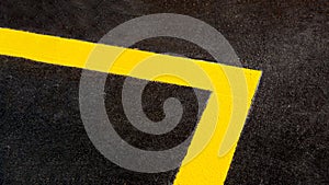 Yellow markings angle of the new highway with tarmac road surface.