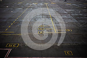 Yellow markings on the asphalt surface at the airport