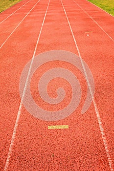 Yellow marks. White lines and texture of running racetrack, red racetrack, in outdoor stadium