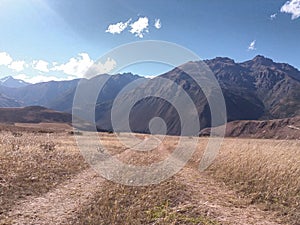 Yellow meadow with highway and mountains photo