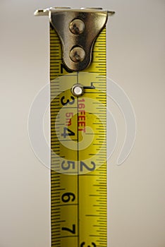Yellow measuring tape metric and feet