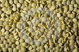 Yellow medicines background closeup. Drugs, painkillers, colds