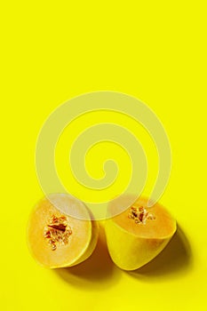 Yellow melon cut in two on yellow background. Abstract food background, yellow colors.