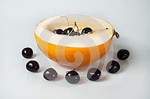 Compisition on white background with fruit. Melon and cherrys