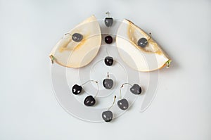 Compisition on white background with fruit. Melon and cherrys