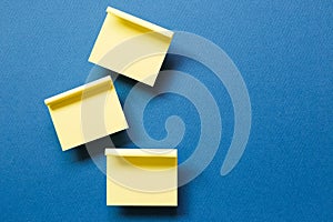 Yellow memo pad sticky note on blue background
