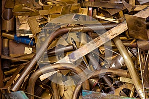 Yellow metal from brass. remnants of brass processing after punching. brass details close-up photo