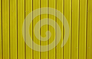 yellow metal decking. new, modern Sheets of yellow corrugated iron. Texture of green metal fence, roofing