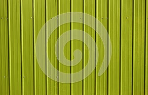 yellow metal decking. new, modern Sheets of yellow corrugated iron. Texture of green metal fence, roofing