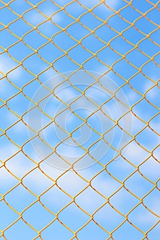 Yellow metal grid on the blue sky background