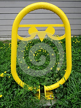 Yellow metal owl-shaped bike rack.