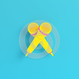 Yellow microphone on bright blue background in pastel colors. Minimalism concept