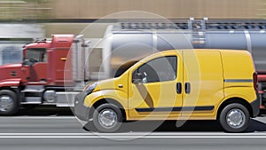 Yellow Mini Van with a Fuel Tanker in Broad Daylight