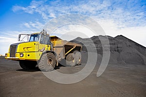 Yellow Mining Dump Truck transporting Manganese for processing