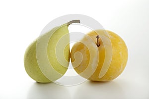 Yellow Mirabelle and Pear on white background