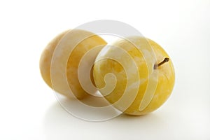Yellow Mirabelles on white background