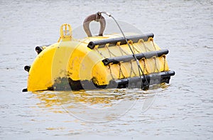 Yellow mooring buoy at sea with navigation light