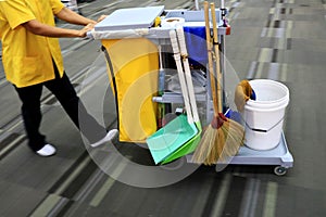 Yellow mop bucket and set of cleaning equipment in the airport