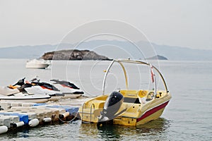 Yellow motor boat with jet ski on a calm blue sea of Bodrum, Turkey