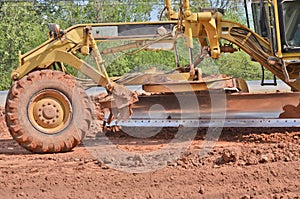 Yellow motorgrader on the road