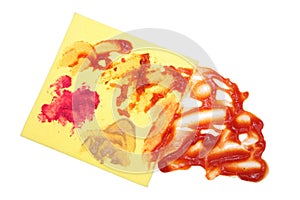Yellow napkin stained with mustard and horseradish ketchup stains isolated