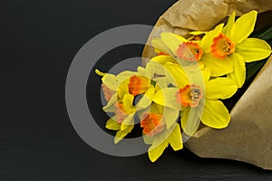Yellow narcissus flowers on black table