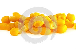 Yellow natural corn seeds isolated on white background. macro