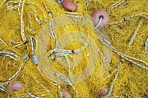 A yellow net for fishing with rope and red benefits
