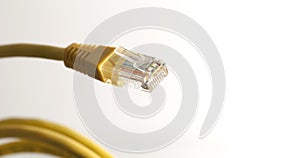 Yellow network cable with RJ45 connector on white background