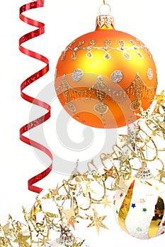 Yellow New Year's sphere on a background of a tinsel 2