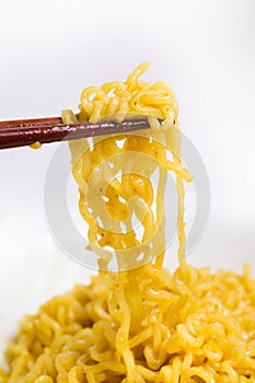 Noodles on a chopstick in white background