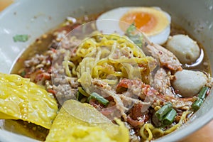 Yellow noodles with Tom Yum soup with egg