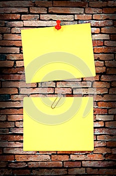 Yellow note on old brick wall