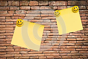 Yellow note pad on brick wall