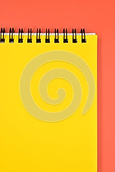 yellow notebook on orange background, stationery for office