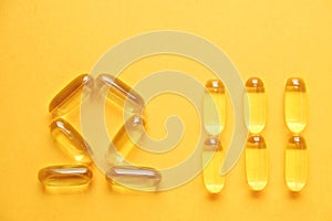 Yellow nutritional supplement pills full of Omega 3 fatty acids.