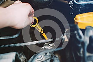 Yellow nylon dipstick check oil level in car engine