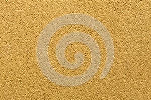 Yellow ochre painted stucco wall. Background texture photo