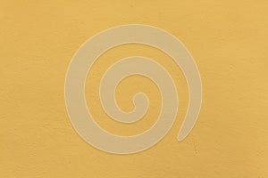 Yellow ochre painted stucco wall. Background texture photo